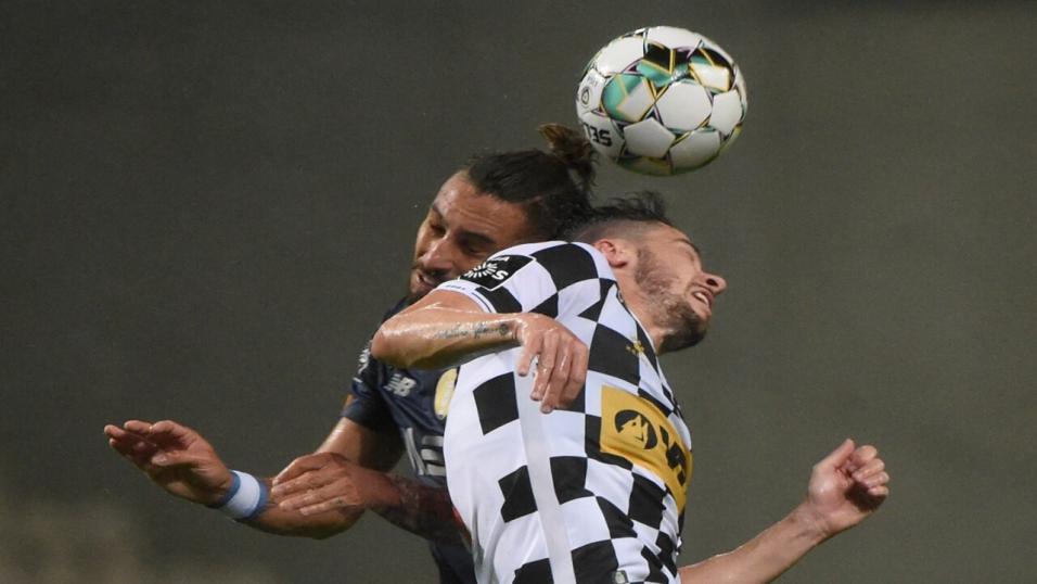 A Boavista player challenges for a header against Porto